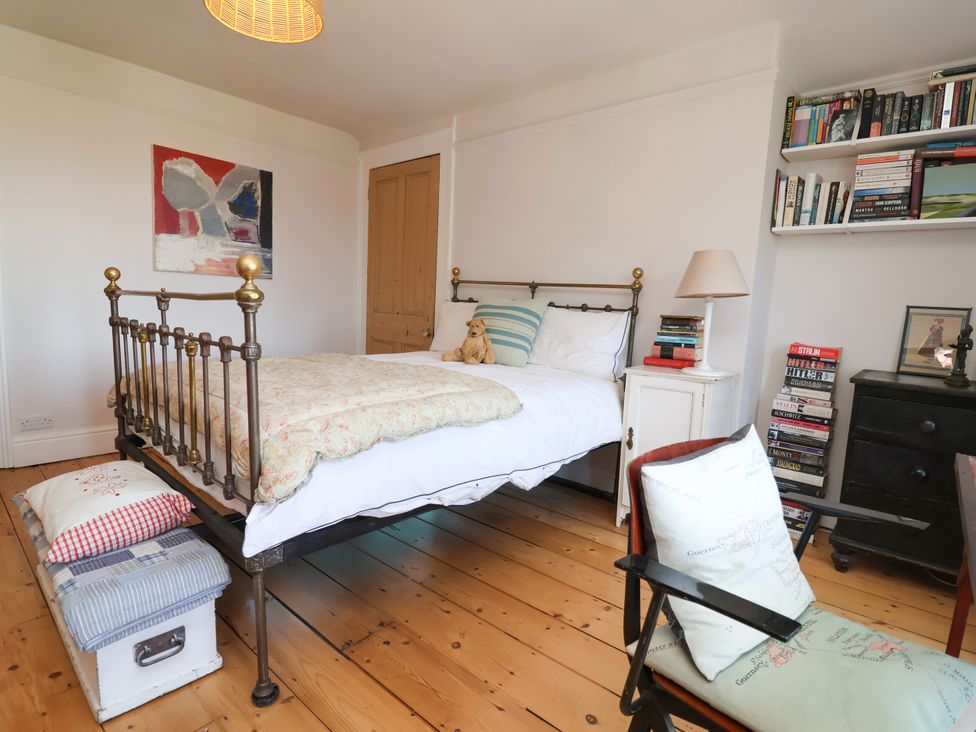 A bedroom with a bed and a bookshelf at 34 Eaton Road Chester