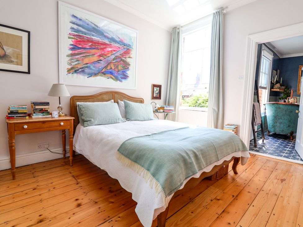 A bedroom with a bed and nightstand at 34 Eaton Road in Chester