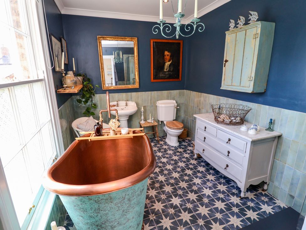 A bathroom with a copper bathtub and sink at 34 Eaton Road Chester