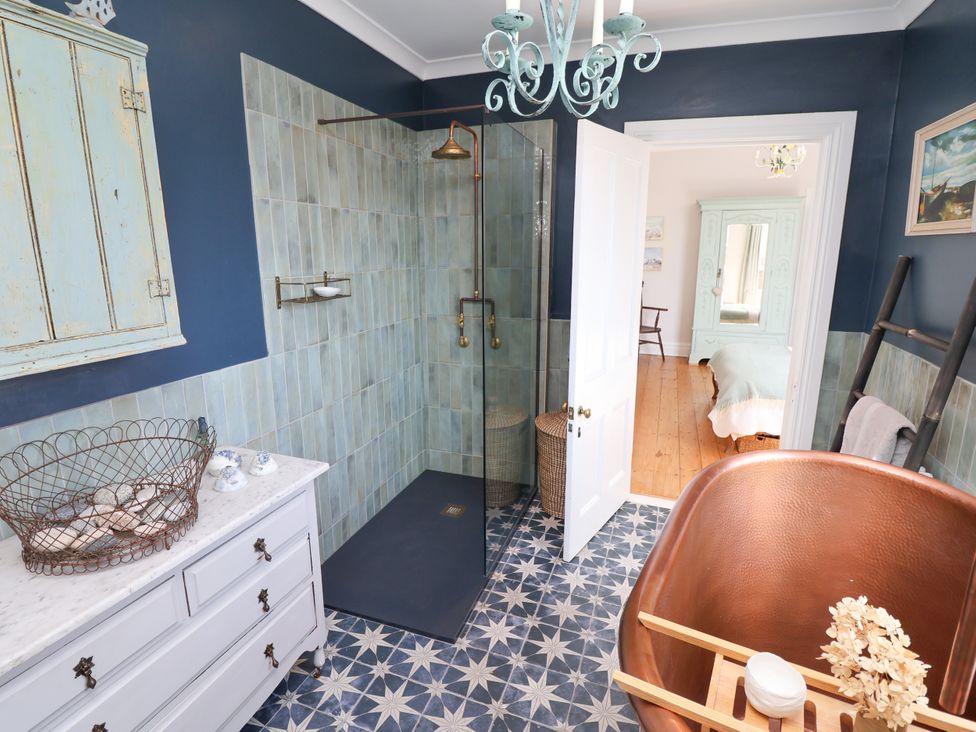 A bathroom with a shower and a bathtub at 34 Eaton Road in Chester