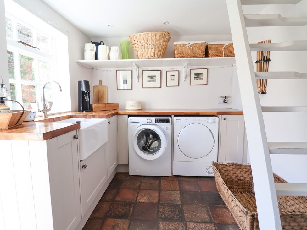 A laundry room with appliances and countertop at 34 Eaton Road Chester