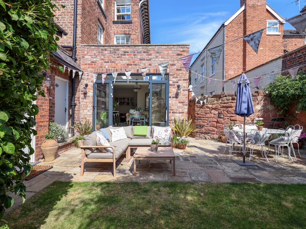 A garden with seating area and patio table at 34 Eaton Road Chester