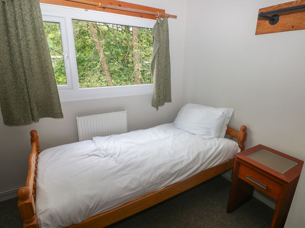 A bedroom with a single bed and a window at Cabin No. 6 - Salt and Fern Cabins in Goytre near Port Talbot