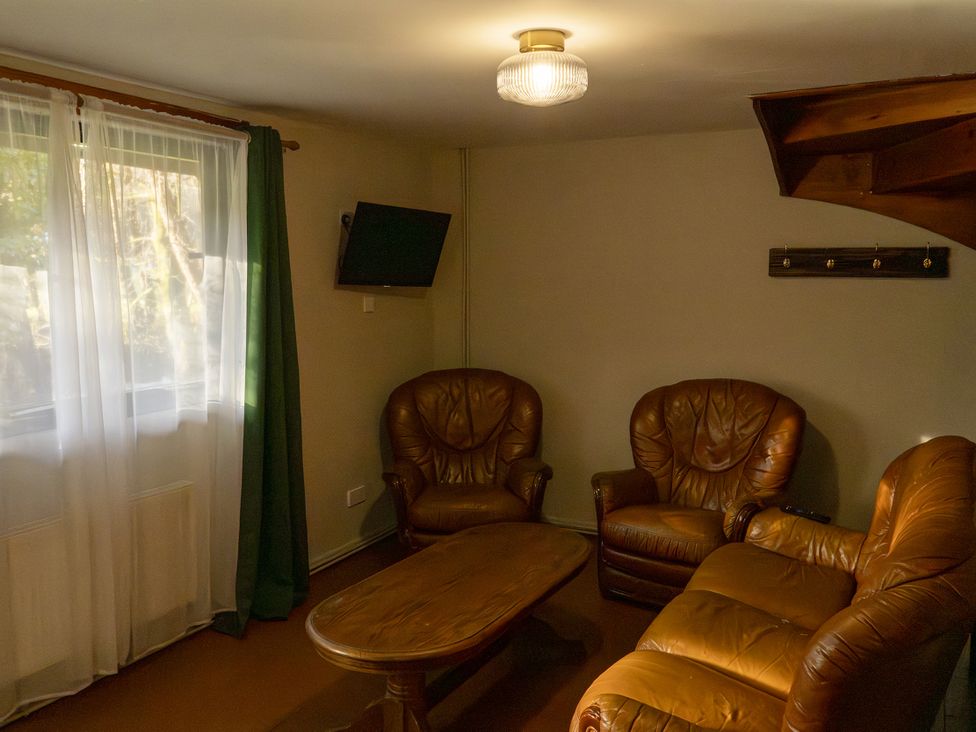 A living room with a sofa and coffee table at 3 bedroom Cabin (7 of 13) Port Talbot