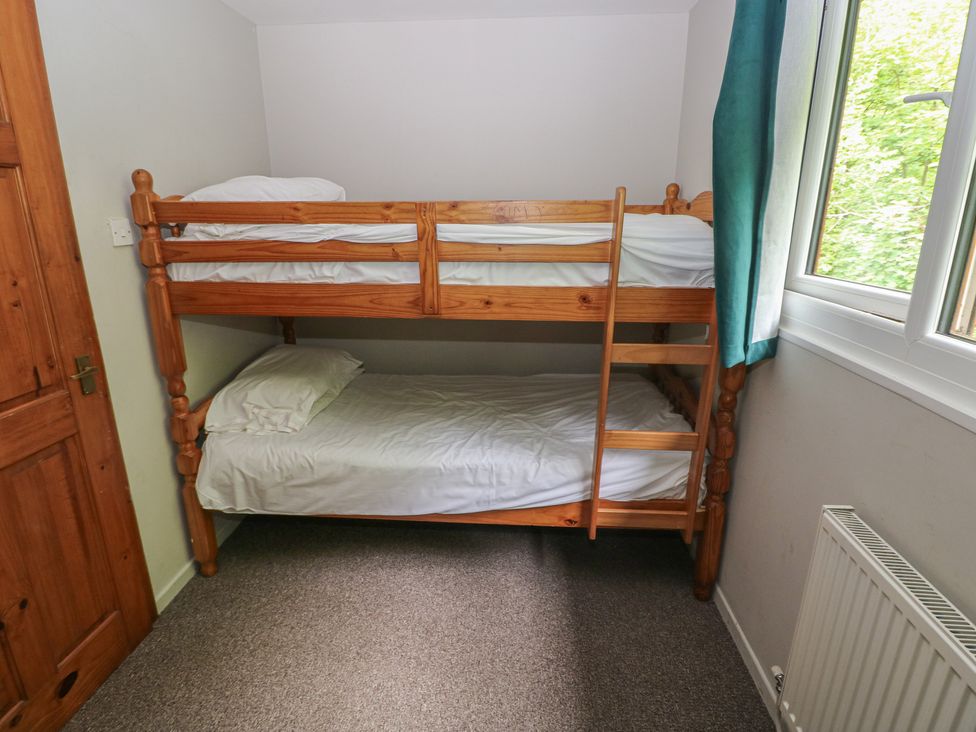 A room with a bunk bed with white bedding at Cabin No. 7 - Salt and Fern Cabins, Goytre near Port Talbot