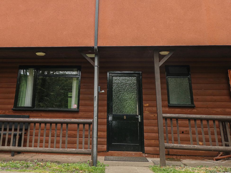 An entrance with a door and windows at Cabin No. 8 - Salt and Fern Cabins Goytre near Port Talbot