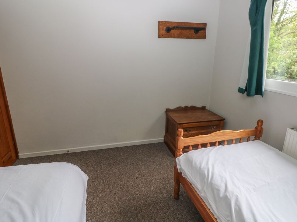 A bedroom with two beds and a wooden drawer at Cabin No. 8 - Salt and Fern Cabins Goytre near Port Talbot