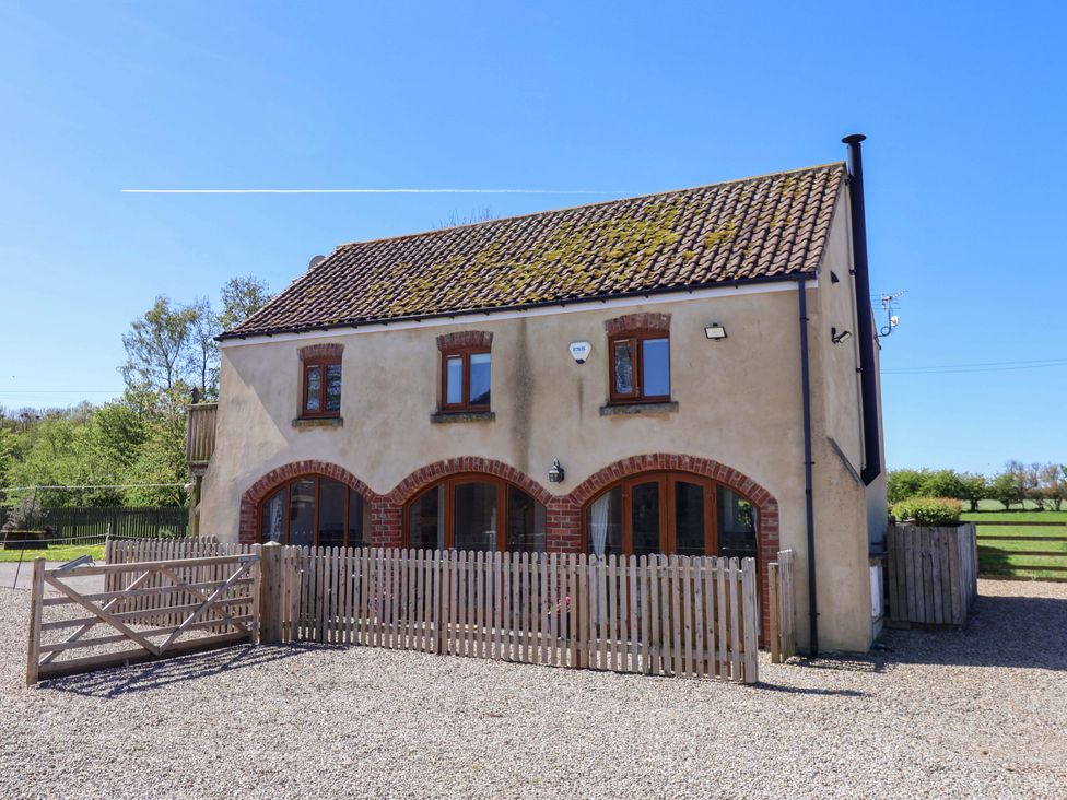 An exterior view of a house with a fence at The Annexe at Dalby Carr
