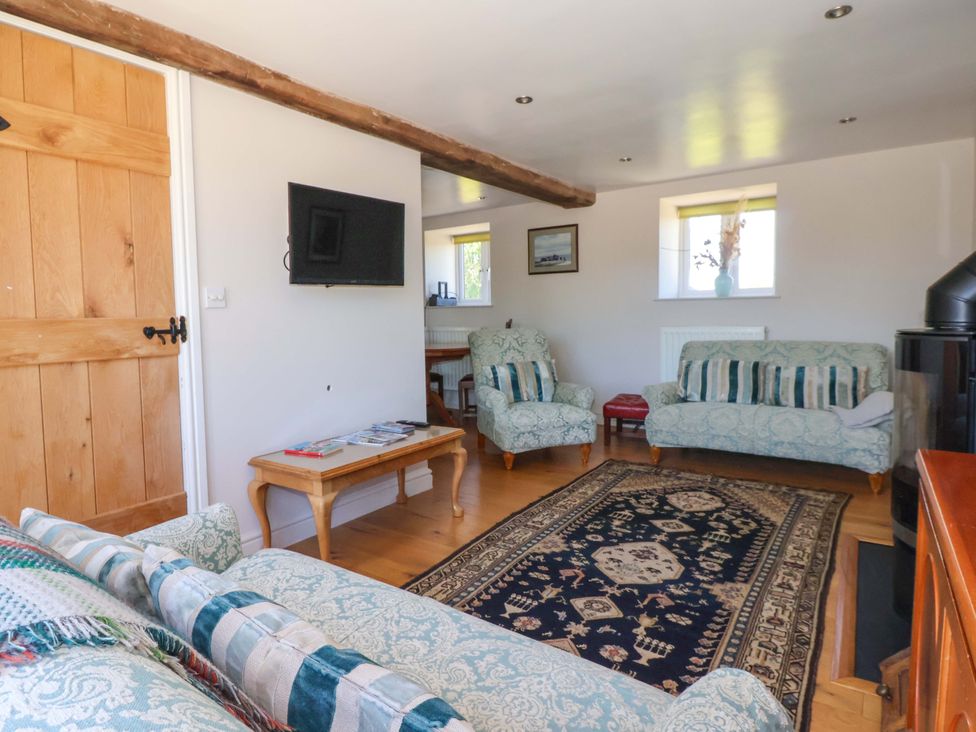 A living room with sofas and a television at The Annexe at Dalby Carr