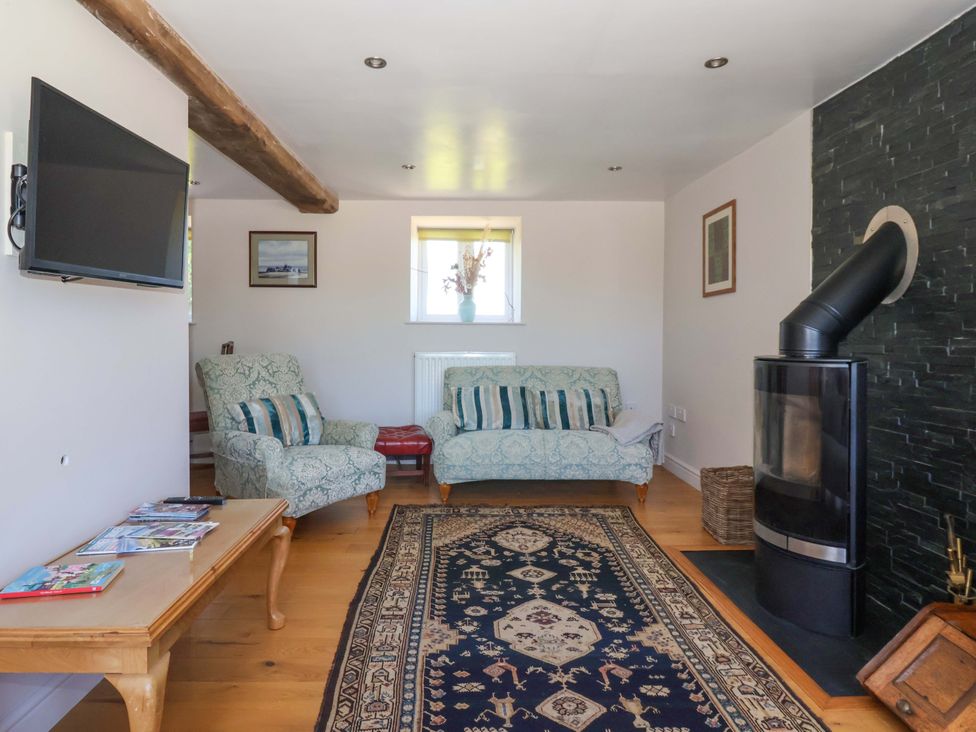 A living room with a sofa and TV at The Annexe at Dalby Carr