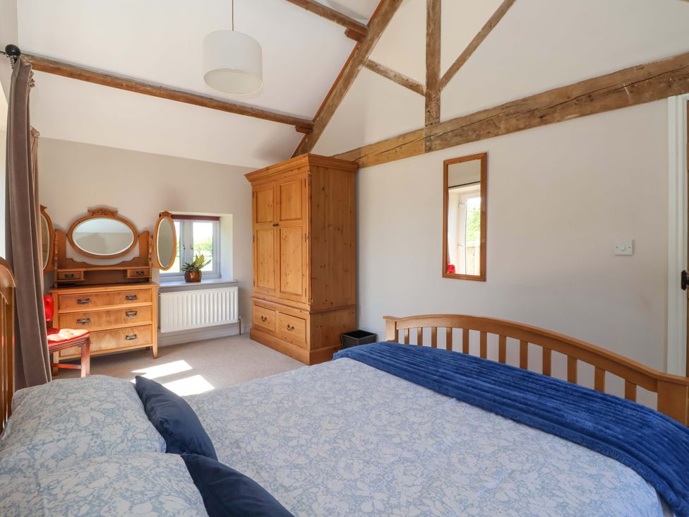 A bedroom with a bed and furniture at The Annexe at Dalby Carr
