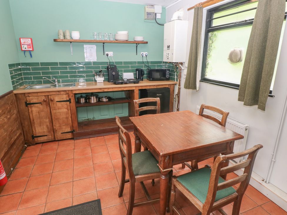 A kitchen with a table and chairs at Cabin No. 9 - Salt and Fern Cabins Goytre near Port Talbot