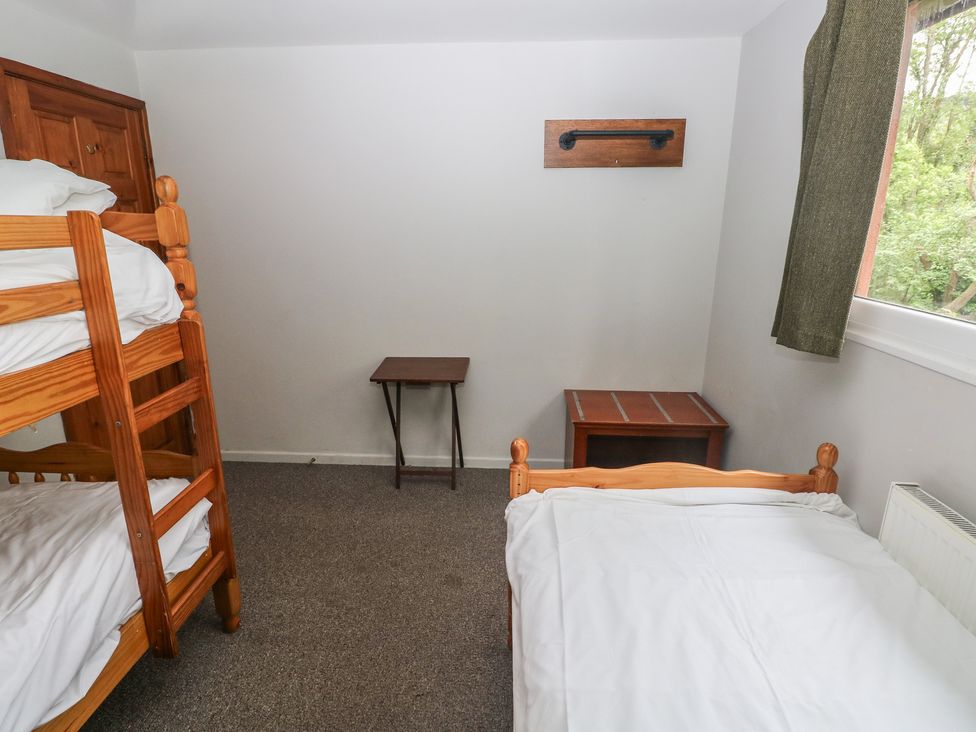 A bedroom with a bunk bed and a single bed at Cabin No. 9 - Salt and Fern Cabins in Goytre near Port Talbot