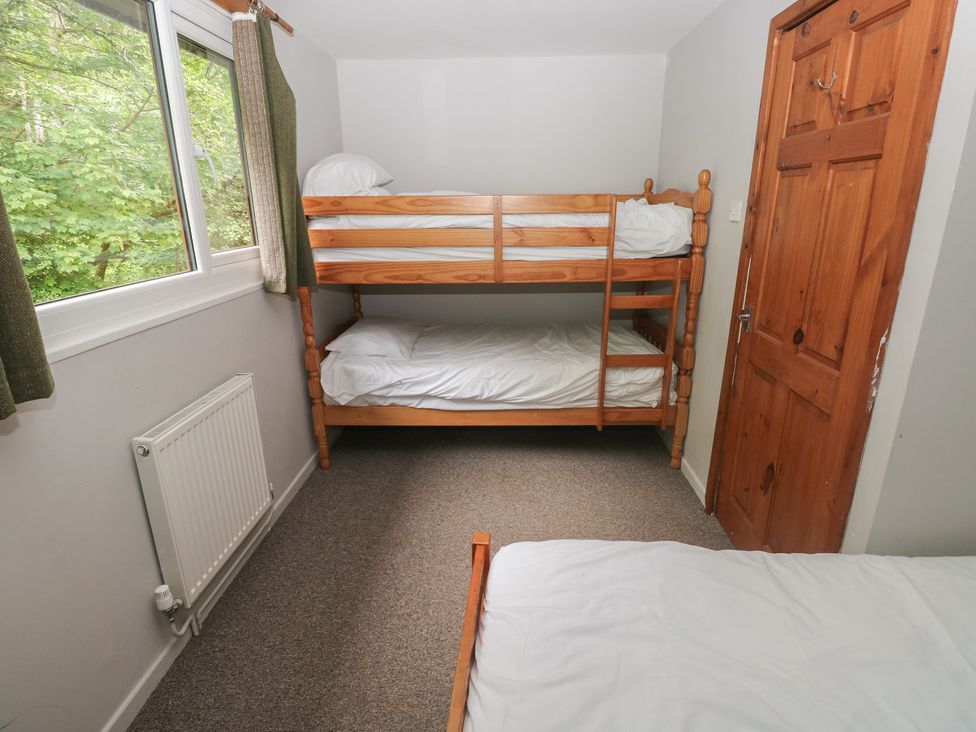 A bedroom with a bunk bed and single bed at Cabin No. 9 - Salt and Fern Cabins Goytre near Port Talbot