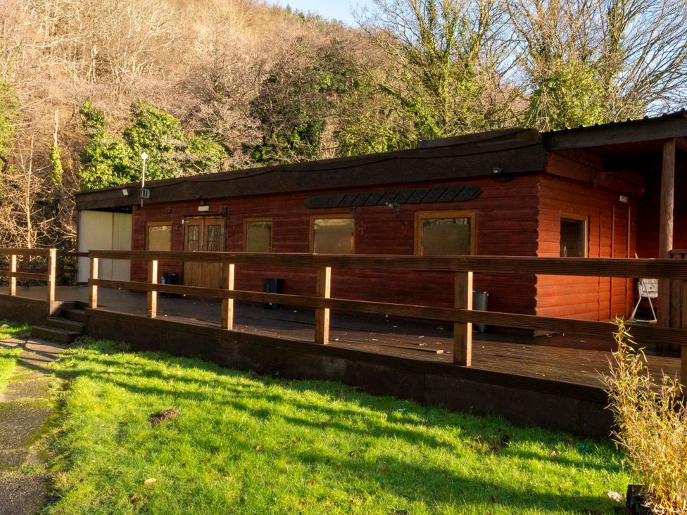A cabin exterior with deck and surrounding grass at 3 bedroom Cabin (10 of 13) Port Talbot