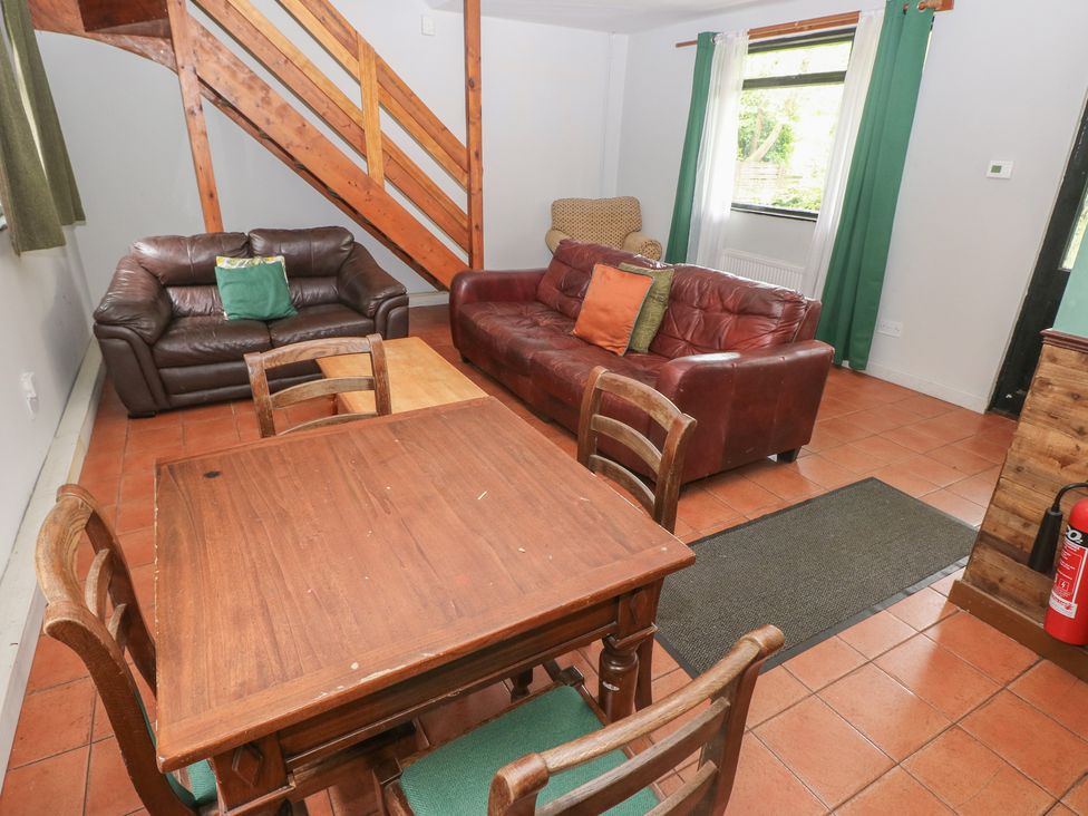A living room with sofas and a dining table at Cabin No. 10 - Salt and Fern Cabins Goytre near Port Talbot