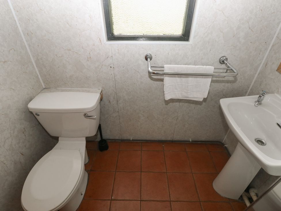 A bathroom with a toilet and sink at Cabin No. 10 - Salt and Fern Cabins near Goytre