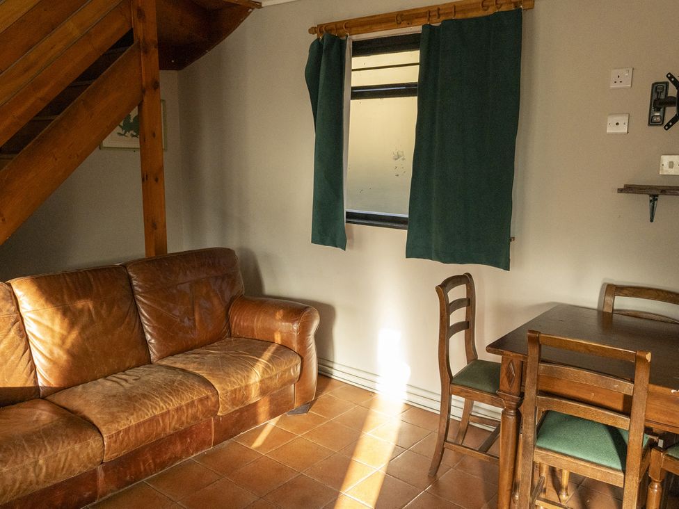 A living room with a sofa and dining table at 3 Bedroom Cabin (11 of 13) Port Talbot