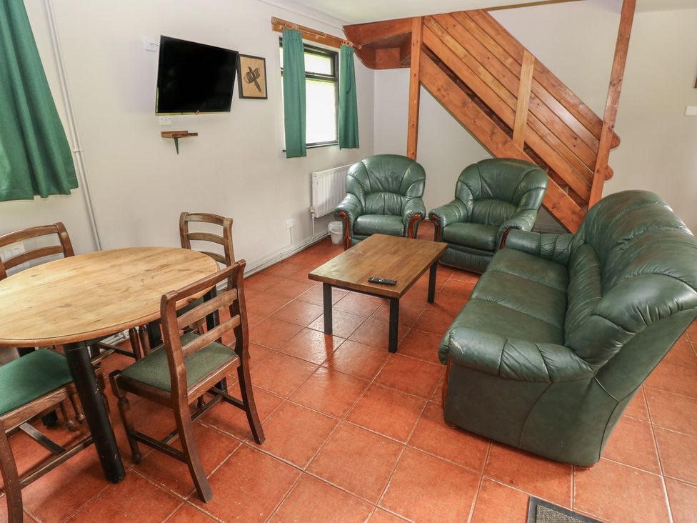 A living room with chairs and a table at Cabin No. 11 - Salt and Fern Cabins, Goytre near Port Talbot