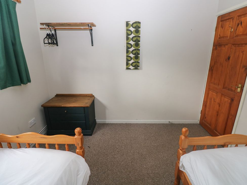 A bedroom with two beds and a wooden chest at Cabin No. 11 - Salt and Fern Cabins, Goytre near Port Talbot
