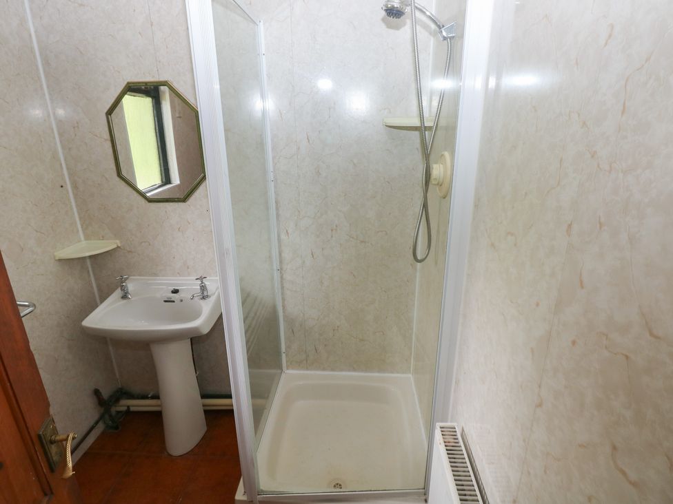 A bathroom with a shower and wash basin at Cabin No. 11 - Salt and Fern Cabins Goytre near Port Talbot