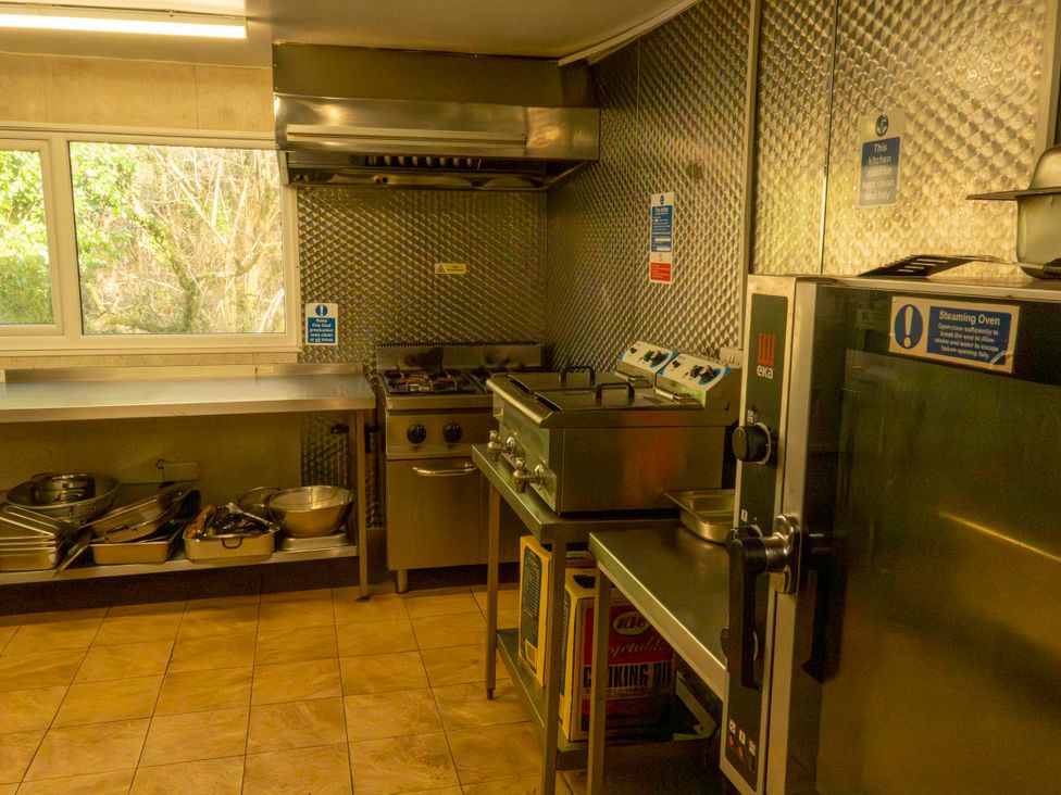 A kitchen with stove, oven, and cooking equipment at 3 bedroom Cabin (12 of 13)