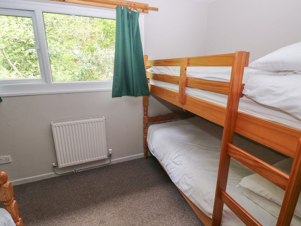 A bedroom with a bunk bed and window at Cabin No. 12 - Salt and Fern Cabins Goytre near Port Talbot