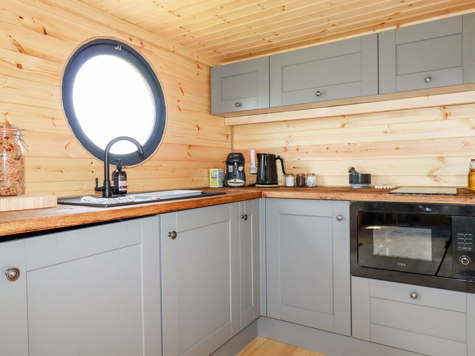 A kitchen with a sink and coffee machine at The Olju in Truro