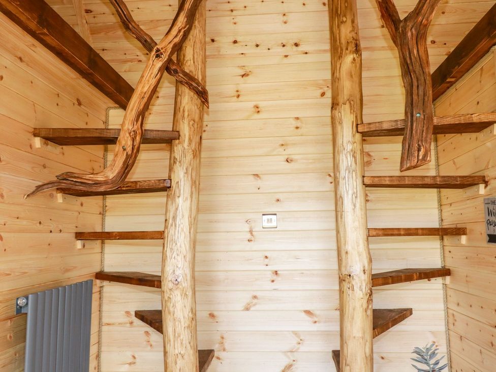 A staircase with wooden steps and railing at The Olju in Truro