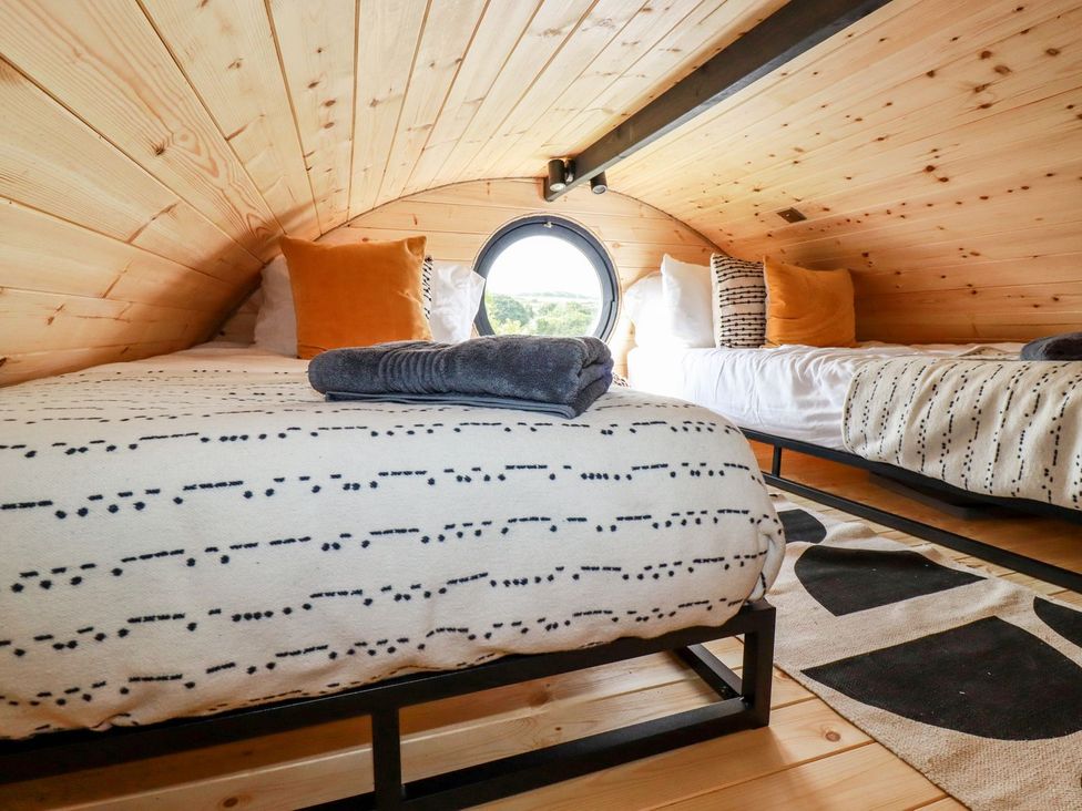 A bedroom with two beds and a window at The Olju in Truro