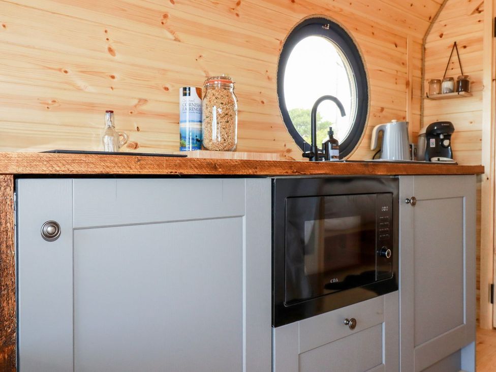 A kitchen with cabinets and a microwave at Stargaze in Truro
