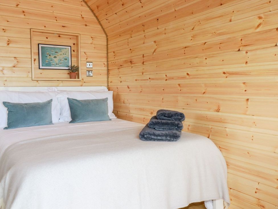 A bedroom with a bed and cushions at Stargaze in Truro