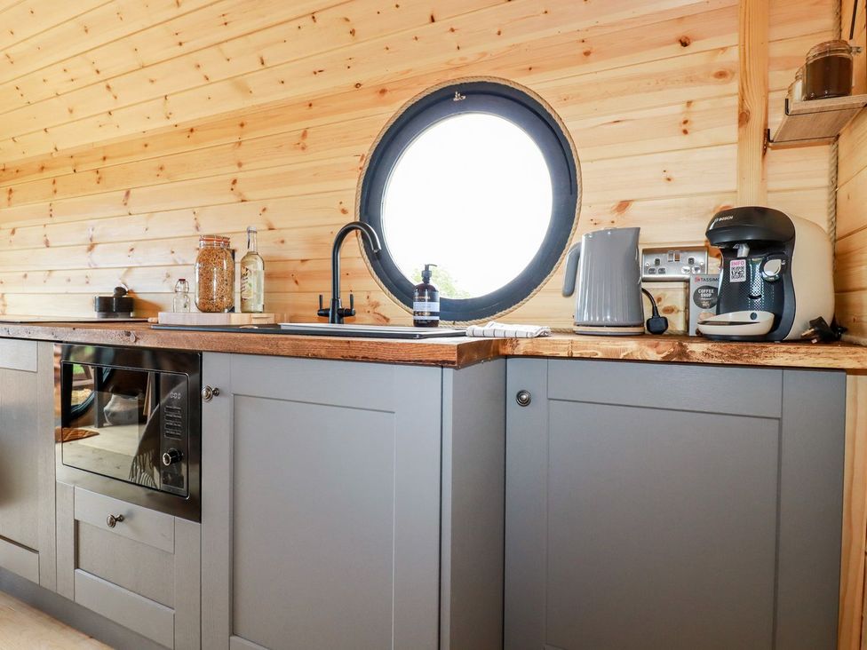 A kitchen with a sink, cabinets, and appliances at Stargaze in Truro