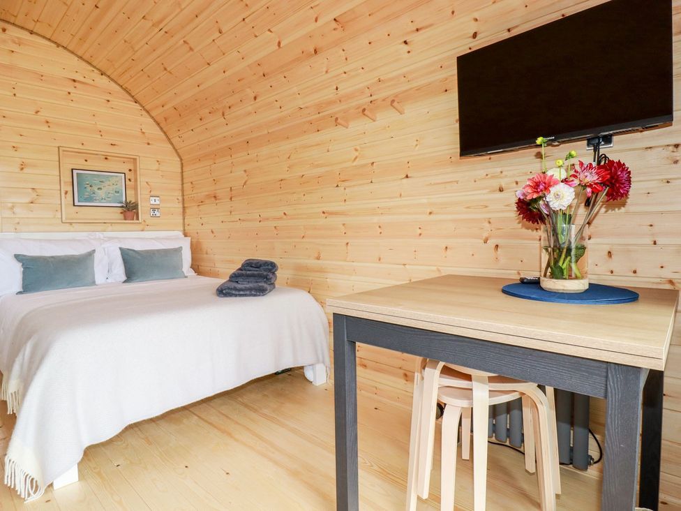 A bedroom with a bed and a table at Stargaze in Truro
