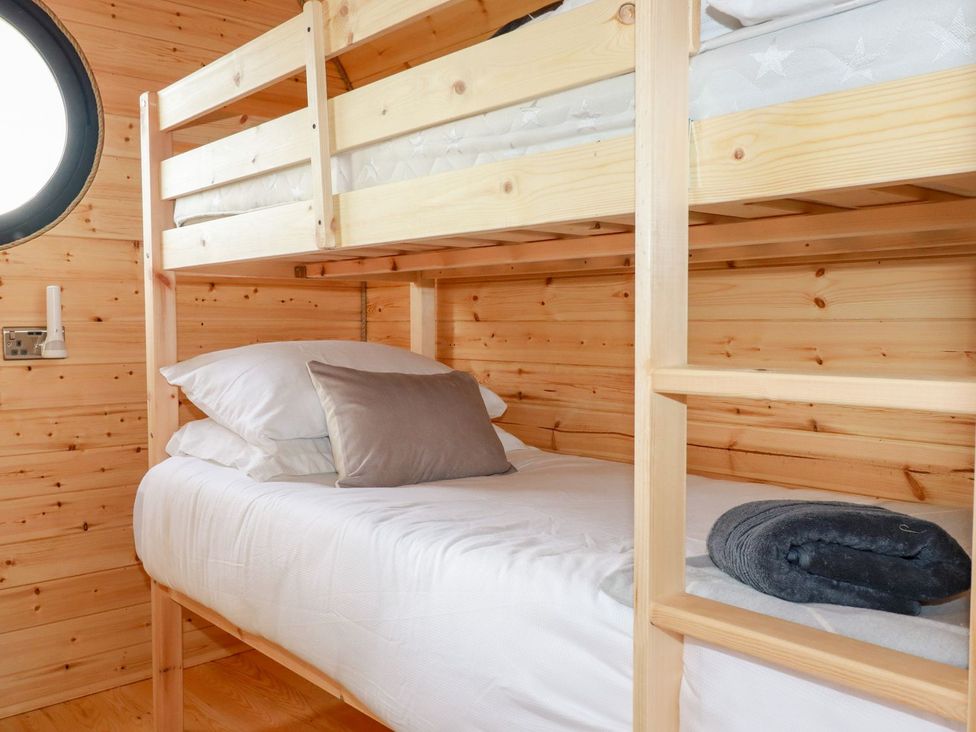 A bedroom with a bunk bed and pillows at Stargaze in Truro