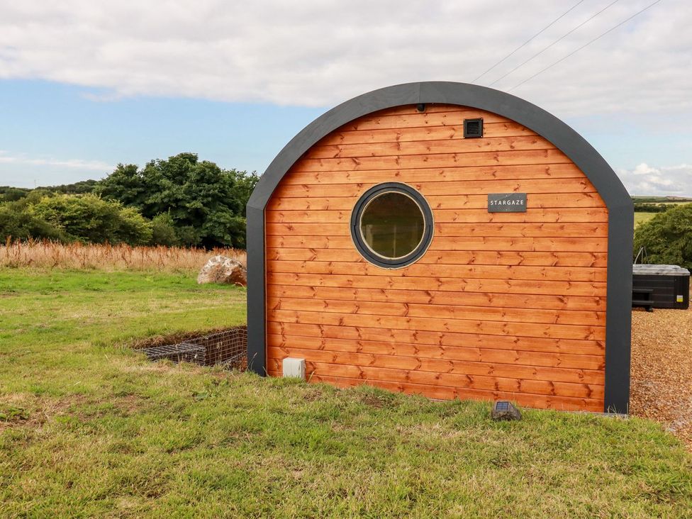 A wooden cabin with a round window at Stargaze in Truro