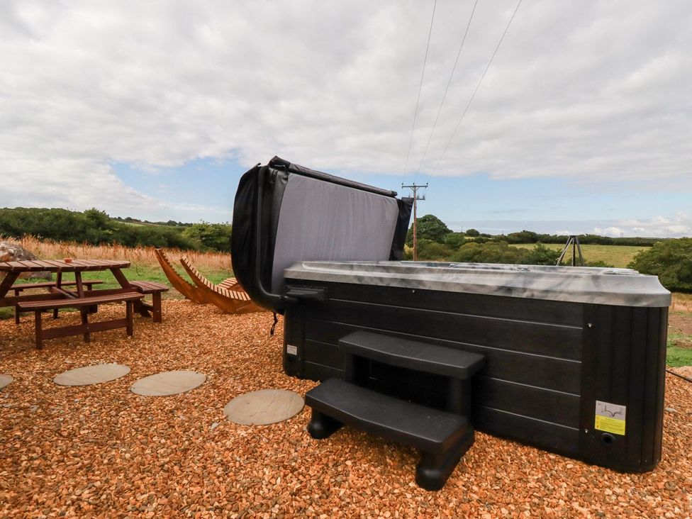 An outdoor area with a hot tub and hammock at Stargaze in Truro