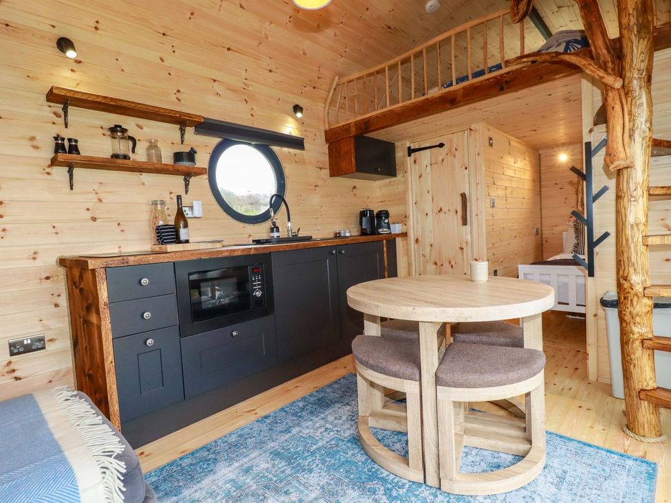 A kitchen with a table and chairs at The Palm in Truro