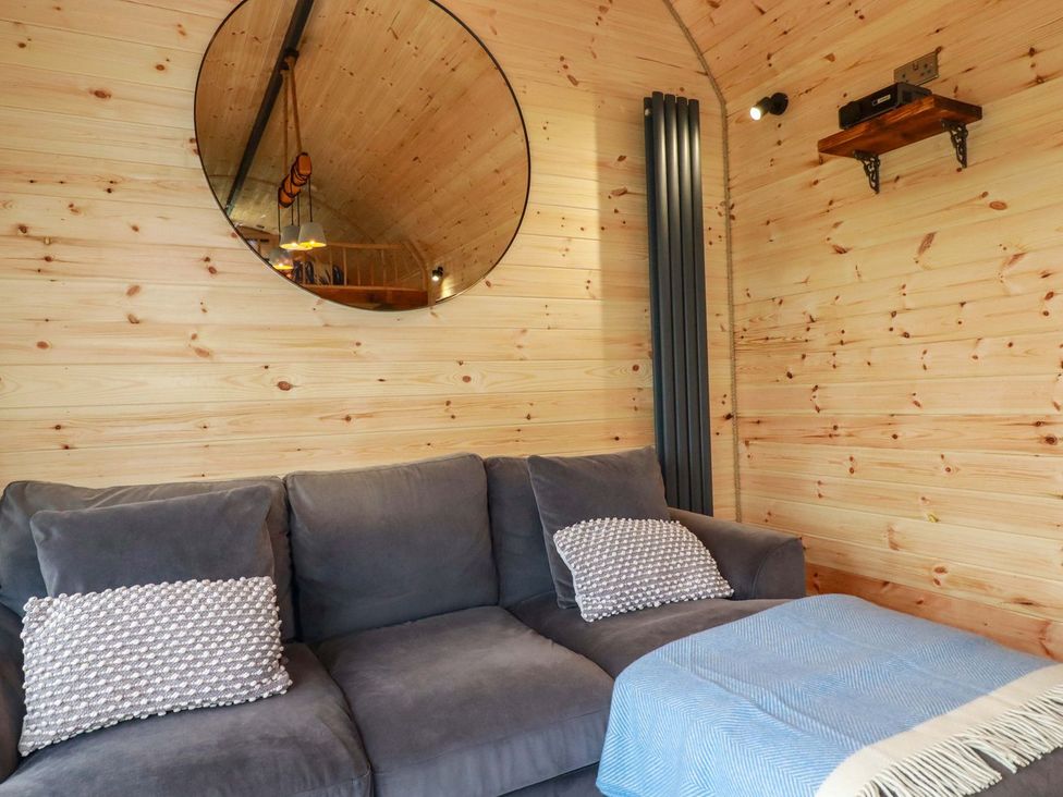 A snug with a sofa and cushions at The Palm in Truro