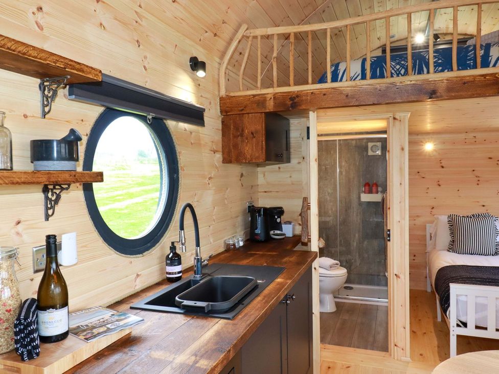 A kitchen with a sink and coffee maker at The Palm in Truro