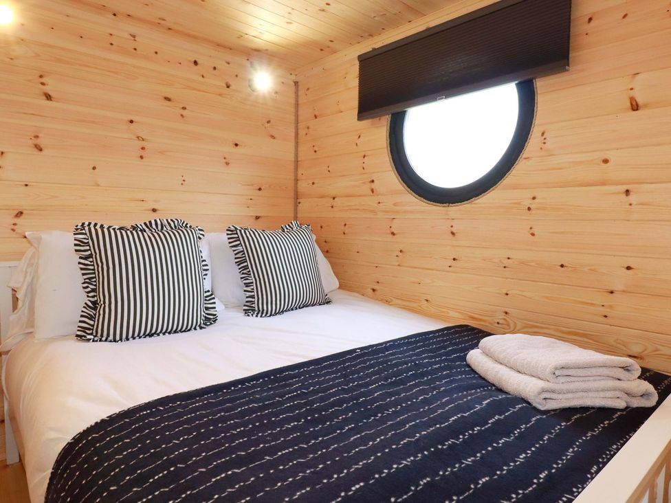 A bedroom with a bed and pillows at The Palm in Truro