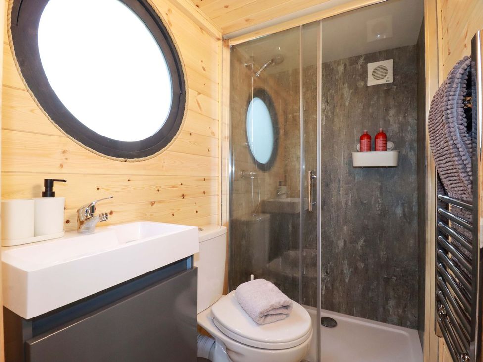 A bathroom with a shower and sink at The Palm in Truro