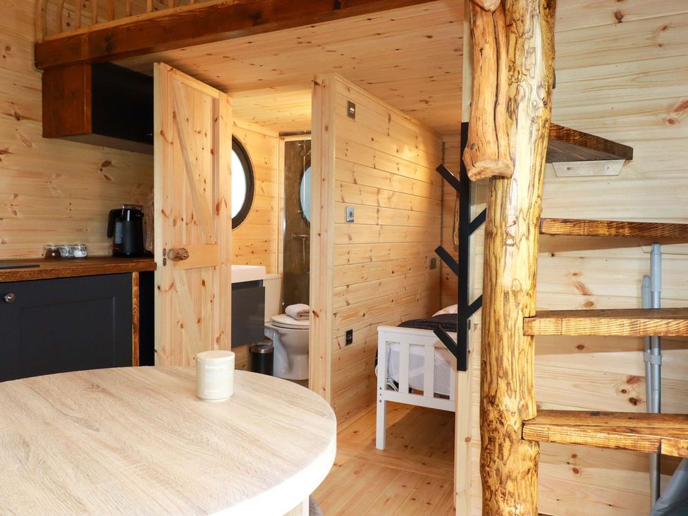 A bathroom with a toilet and sink at The Palm in Truro