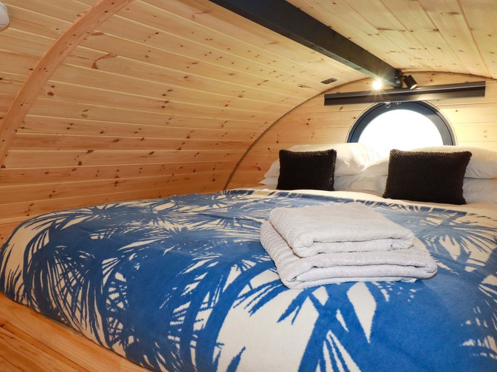 A bedroom with a bed and pillows at The Palm in Truro