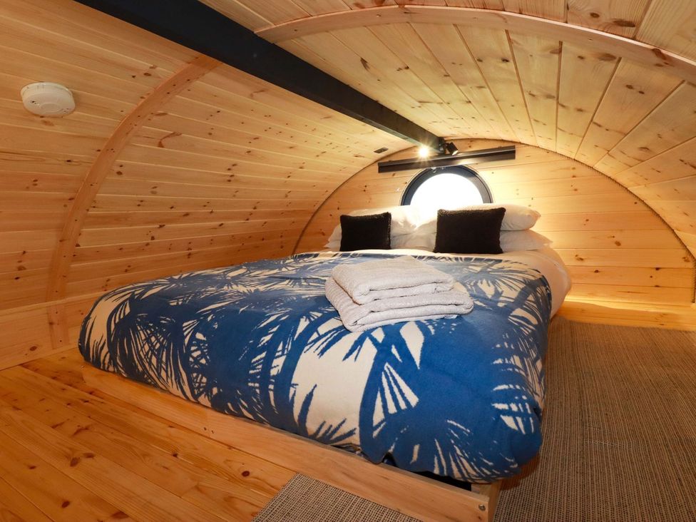 A bedroom with a bed and towels at The Palm in Truro