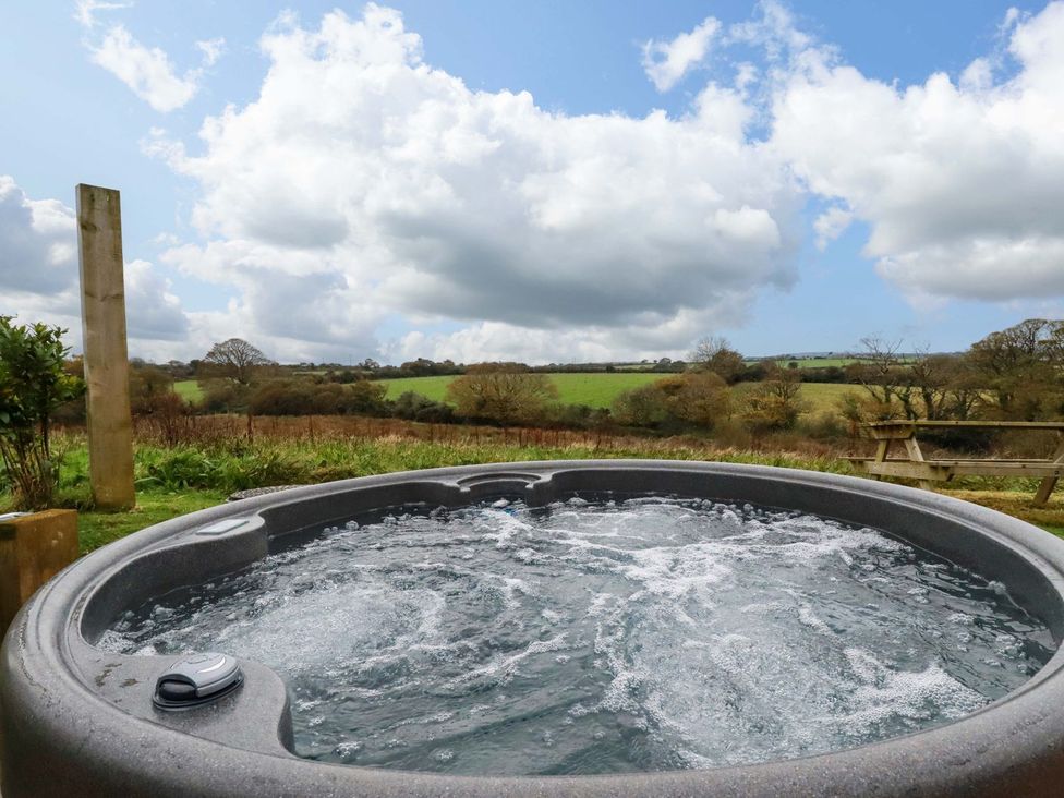 A hot tub with a view of fields at The Palm in Truro