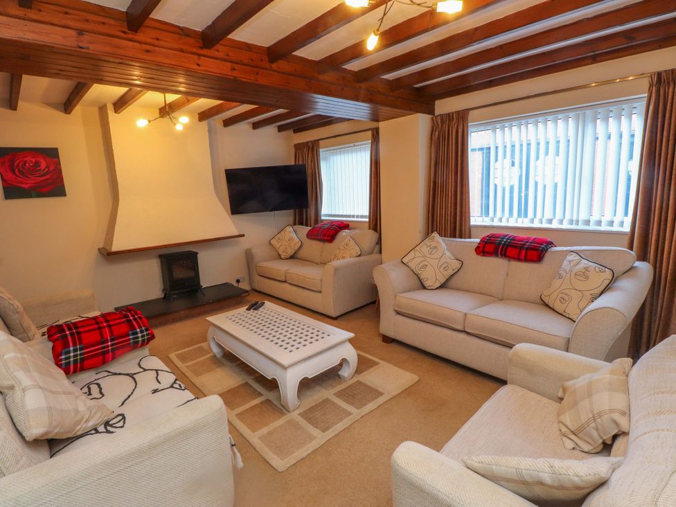A living room with sofas and a coffee table at The Old Stables in Rhos-On-Sea