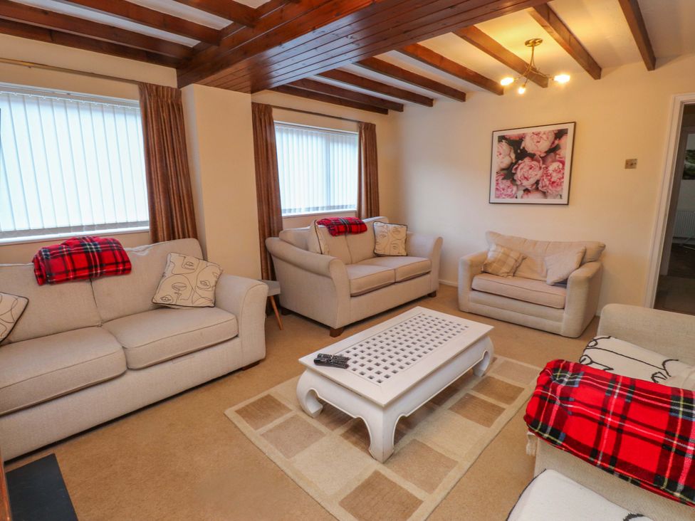 A living room with sofas and a coffee table at The Old Stables in Rhos-On-Sea