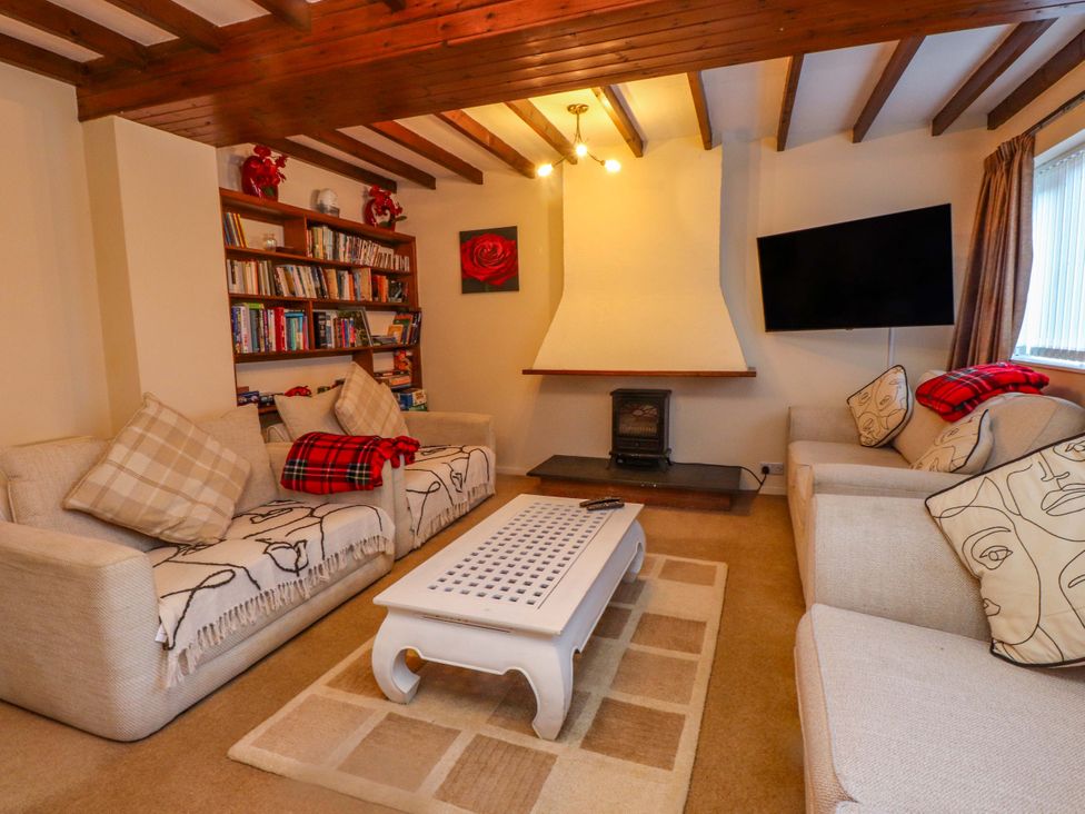 A living room with a sofa and coffee table at The Old Stables Rhos-On-Sea