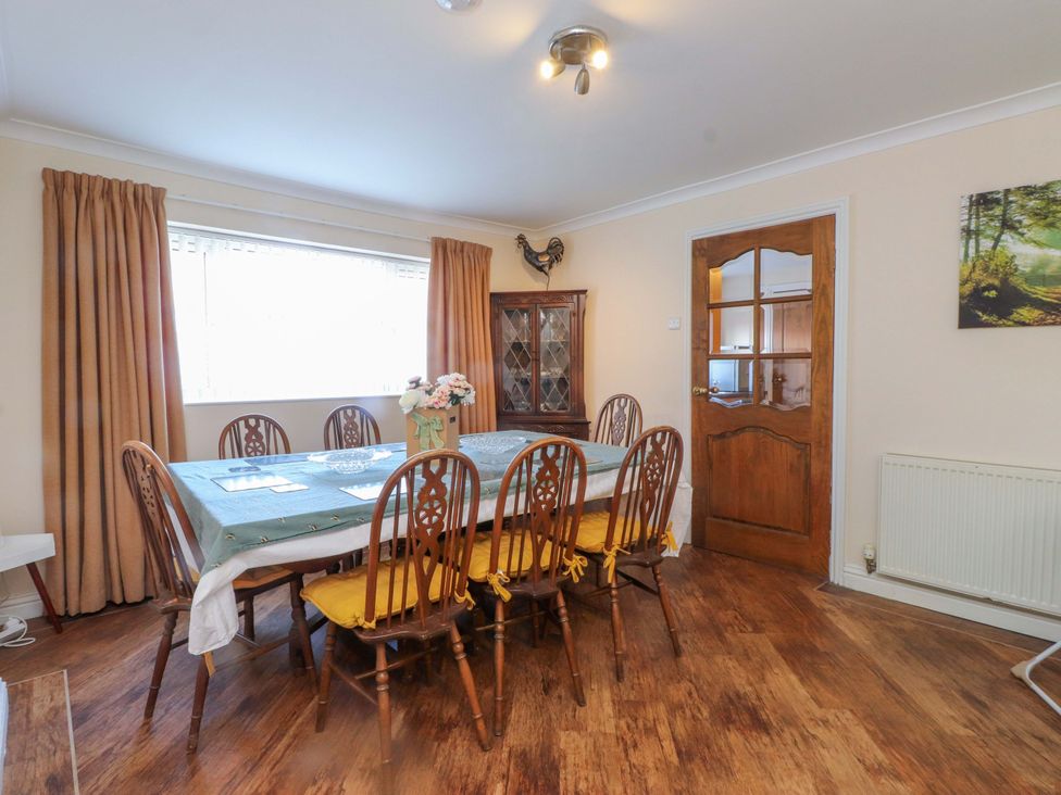 A dining room with a table and chairs at The Old Stables in Rhos-On-Sea